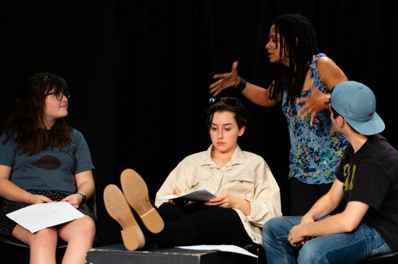 Dramatic Writing students in mid-presentation in a black box theatre